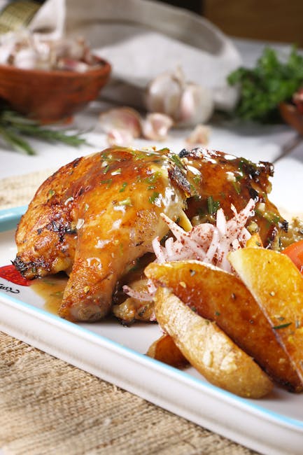 Delicious roasted chicken paired with golden potatoes and fresh herbs on a rustic platter.