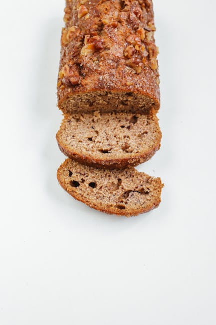 Close-up of sliced banana bread on a white surface. Perfect for food photography.